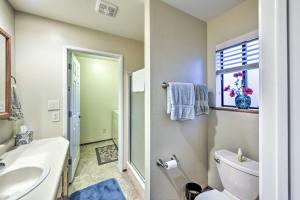 a bathroom with a toilet and a sink and a window at Near Fishing and Hiking Pioneer Cabin with Decks in Pioneer +22 photos