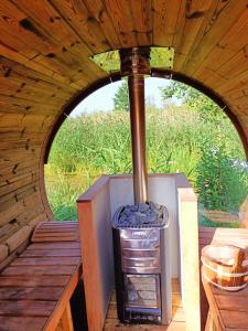 an outdoor oven in a wooden cabin with a window at Agroturystyka Jeleń in Jeleń