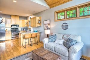 a living room with a couch and a kitchen at Waterfront Mound Retreat with Boat Dock Access! in Mound