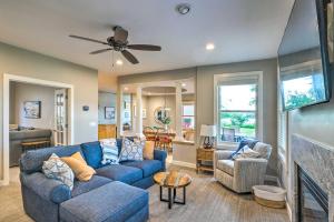 a living room with a blue couch and chairs at Waterfront Mound Retreat with Boat Dock Access! in Mound