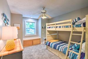 a bedroom with two bunk beds and a desk at Waterfront Mound Retreat with Boat Dock Access! in Mound