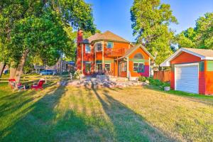 a home with a colorful house at Waterfront Mound Retreat with Boat Dock Access! in Mound