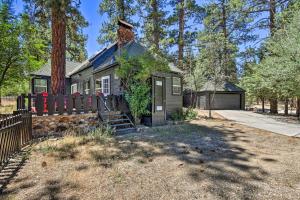 a small house with a fence in front of it at 2 Mi to Big Bear Lake Cabin with Game Room in Big Bear City