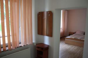 a room with a bed and a dresser next to a window at Willa Maxim in Lądek-Zdrój