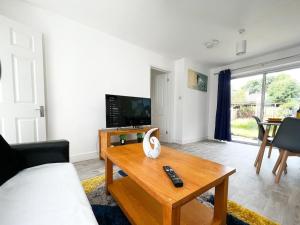 a living room with a couch and a coffee table at Starview Apartment - Hawthorne in Colchester