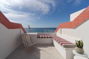 balcón con banco y vistas al océano en SG Canteras View Deluxe, en Las Palmas de Gran Canaria