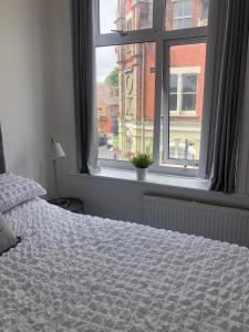 a bedroom with a bed and a window at Charming Apartment in Ashley Cross in Parkstone