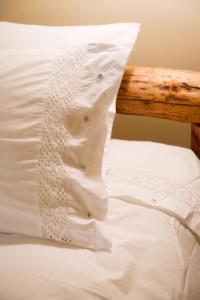 a white pillow sitting on top of a bed at Mir Boutique Hotel in Ioannina