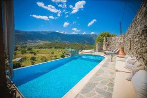 a villa with a swimming pool with a view at Traditional Villa Askyfou in Karés