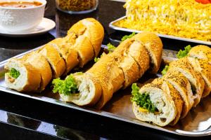 a tray of sandwiches on a table with noodles at Ingleses Park Hotel in Florianópolis