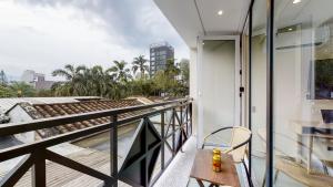 a balcony with a bench and a view of the city at Origen Hotel Boutique in Medellín