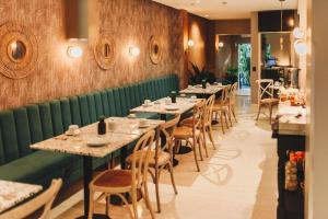 a row of tables and chairs in a restaurant at LG Golden Suites in San Miguel de Tucumán