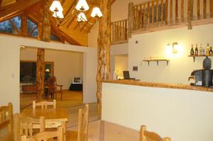 a kitchen and dining room with a table and chairs at La Estancia in Trevelin