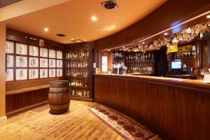 a bar with a barrel in the middle of it at Royal Golf Hotel in Dornoch