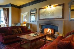 a living room with a couch and a fireplace at Royal Golf Hotel in Dornoch