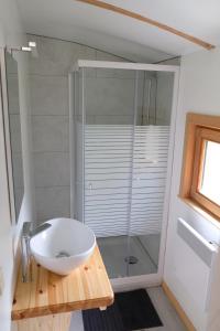 ein Bad mit einem Waschbecken und einer Glasdusche in der Unterkunft Camping des Saules in Jurbise