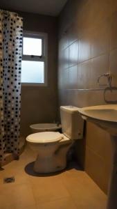 a bathroom with a toilet and a sink at Departamento Soberania totalmente amoblado in La Cieneguita