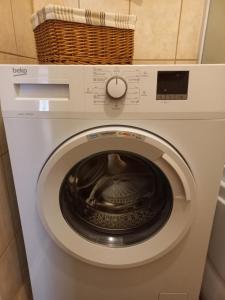 a washing machine with a basket on top of it at Vienibas apartment in Daugavpils