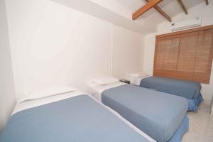 En eller flere senge i et værelse på Cabañas Santorini Santa Marta