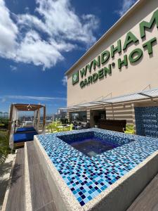 a swimming pool in front of a building at Wyndham Garden Barranquilla in Barranquilla