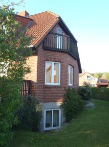 a brick house with a balcony on top of it at Triton II in Hohwacht