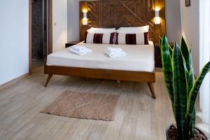 a bedroom with a bed and a potted plant at Adventor Eco-Suites in Rome