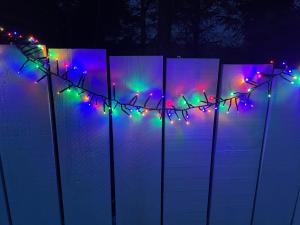 a string of christmas lights on a fence at Bankhead Accommodation with Hot Tub Aberdeenshire in Gamrie