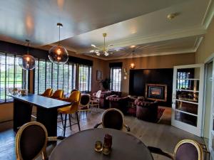 a living room with tables and chairs and a couch at Hotel Lepelbed in Ghent