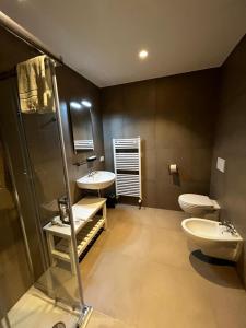 a bathroom with two sinks and a shower and a toilet at Bilo - Apartments for rent in Trento +71 photos