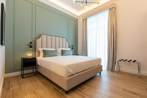 a bedroom with a large bed and a large window at Unico Relais in Naples