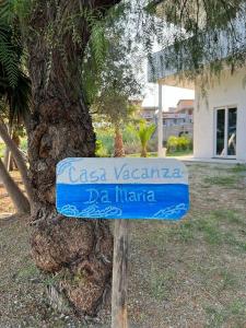 a sign on a pole in front of a tree at Appartamento Da Maria in Caulonia Marina +19 photos