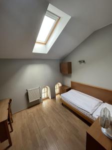 a bedroom with a bed and a skylight at Dom Sonata in Gdańsk
