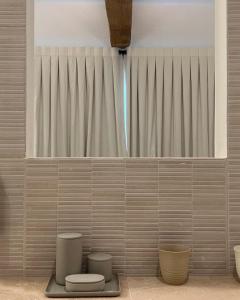 a bathroom with a toilet and two stools at Domaine de Panery in Pouzilhac