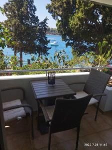 a table and chairs on a balcony with a view of the water at Sea Dreams Apartment in Pula