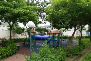 a playground with a blue slide in a park at Ecusuites Jacuzzi Vacacional Ceibos Via a la Costa in Guayaquil