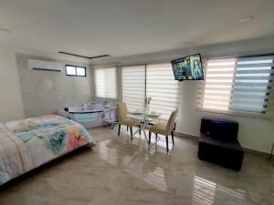 a bedroom with a bed and a table and chairs at Ecuabook Via a la Costa Gye Puerto Azul in Guayaquil +45 photos
