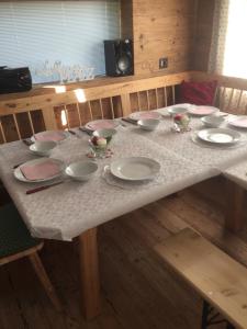 a table with plates and bowls on top of it at Landhaus Waisenegg 