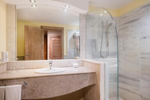 a bathroom with a shower, sink, and tub at Iberostar Bahia - All Inclusive in Praia do Forte