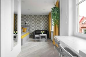 a living room with a bed and a table at SELF CHECK-IN old town STUDIO in Klaipėda