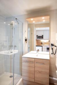 a bathroom with a shower and a sink at Residhome Chartres in Chartres