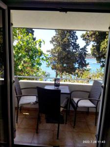 a balcony with a table and chairs and a view of the water at Sea Dreams Apartment in Pula