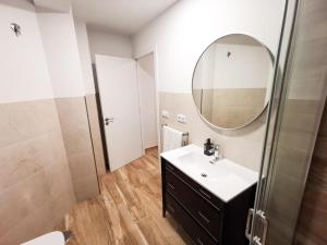 a bathroom with a sink and a mirror at HyP - Esquina Primavera in A Coruña