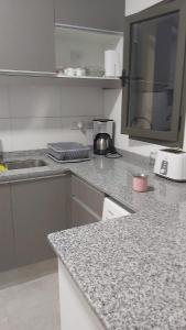 a kitchen with a counter top with a sink and a counter top at S4 Hermoso departamento para conocer Mendoza in Godoy Cruz