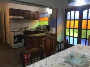 a kitchen with a table and a stove top oven at Residencia La Isabel in San Luis