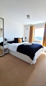 a bedroom with a large bed and a large window at The Property Parlour in Reading