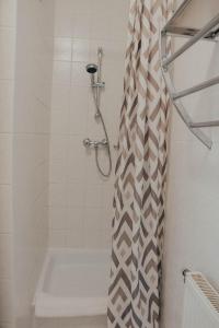 a bathroom with a shower with a shower curtain at Casa Galliera - Apartment in Keszthely