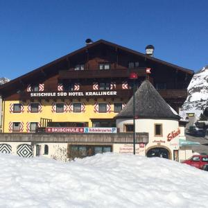 a large ski lodge with snow in front of it at Hotel-Skischule Krallinger in Obertauern