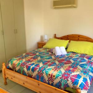 a bedroom with a bed with two towels on it at Apartment with large pool in Limassol