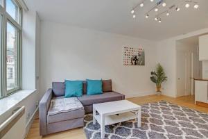 a living room with a couch and a table at Flat C, Old Street in London