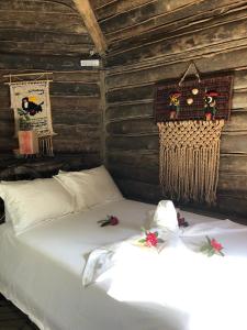 a bedroom with a bed in a log cabin at Pousada Ilhas Do Sol in Senador Amaral